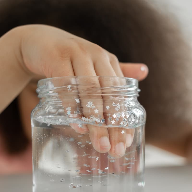 kid putting their hand in a jar of water, sensing temperature